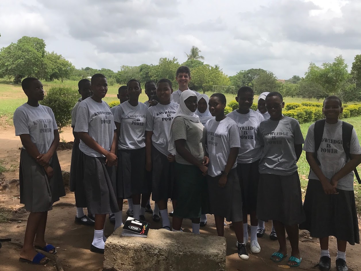 The founder of end world hunger standing with a group of African girls under the shade