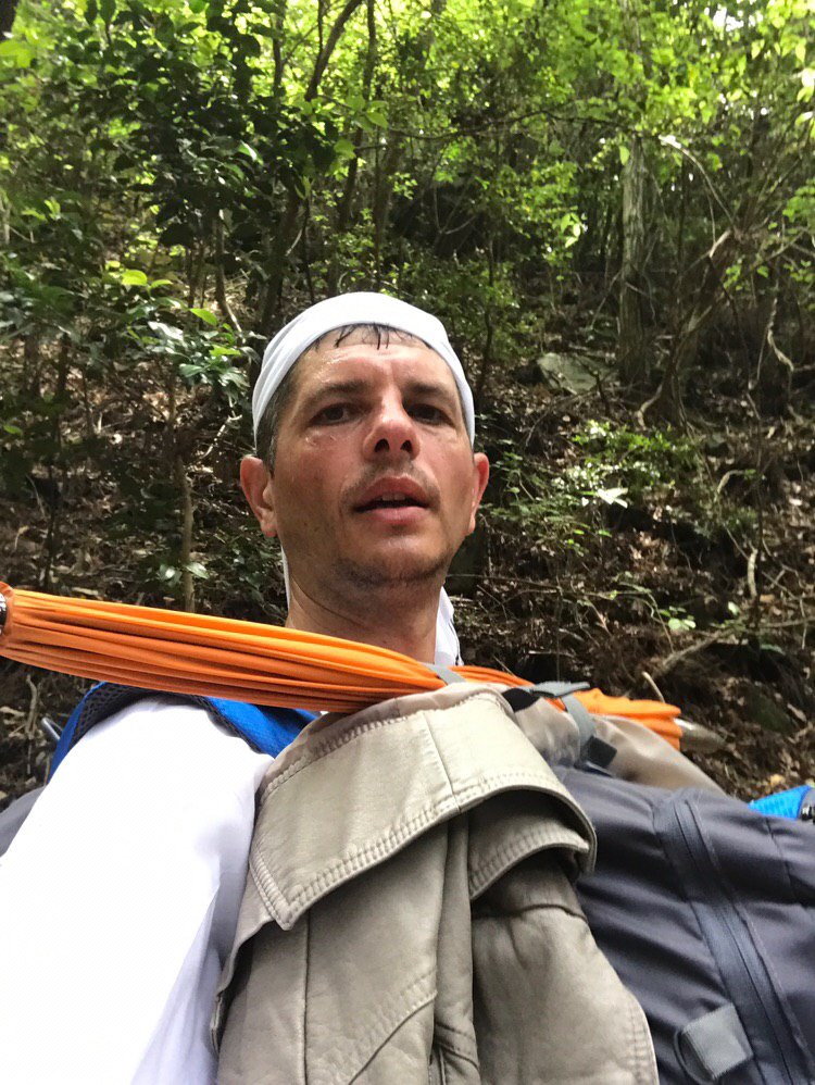 Sergiu Kondanna wearing a white headband in the forest
